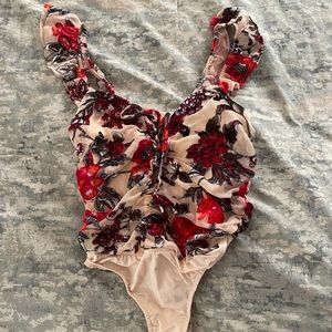 Body suit with front tie